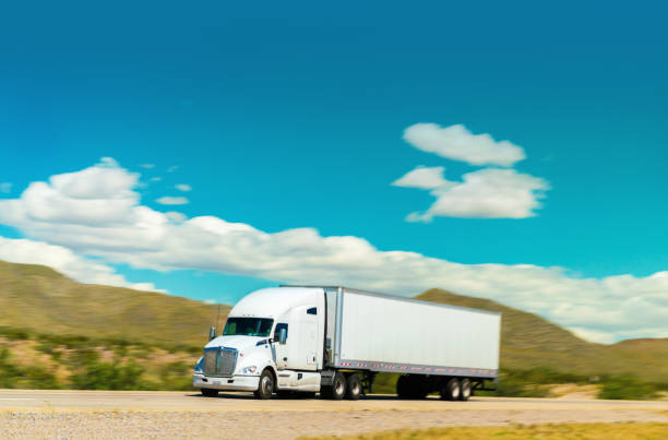 All white semi-truck driving on the highway  - motion blur