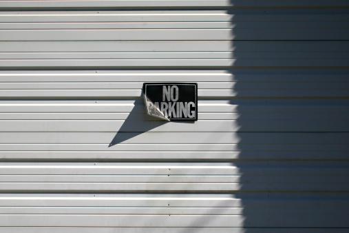 No Parking sign on a garage door.