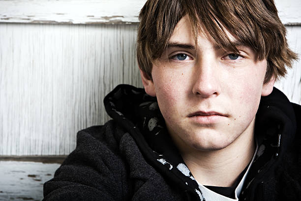 istock Young man with black hoodie looking at the camera 145122697