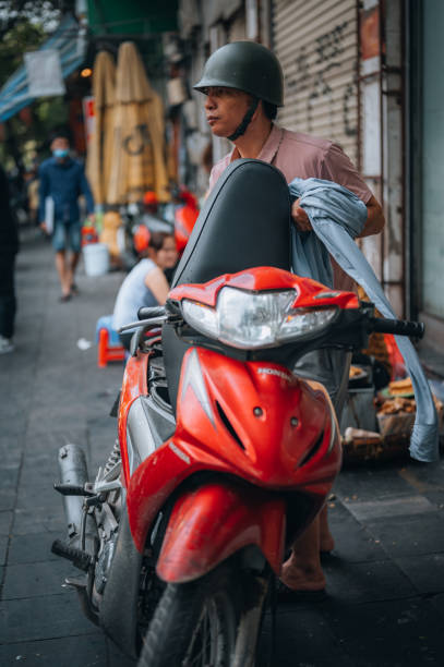 Everyday life on the streets in Hanoi, Vietnam. Hanoi, Vietnam, November 20, 2022,Everyday life on the streets in Hanoi. vietnamese man taxi motorbike driver stock pictures, royalty-free photos & images