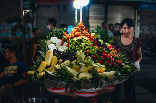 November 20, 2022 Hanoi, Vietnam.A street vendor selling fresh fruit on the streets of Hanoi, Vietnam. Different types of fruit can be seen.
