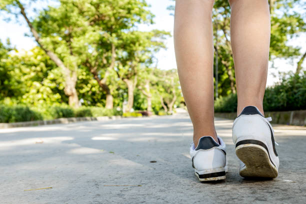 istock Woman with white shoes walking 1451229928