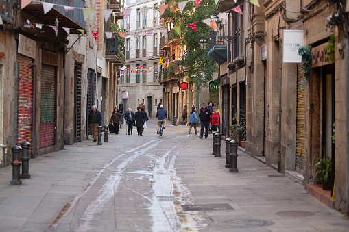 Barcelona, Spain, January 16 2020: View looking down between buildings on either side of one of the numerous small backstreets of Barcelona