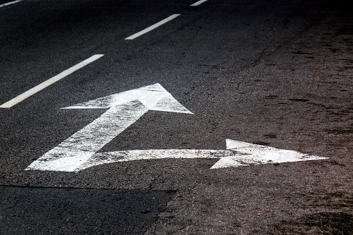 Close up arrow signs on asphalt city road