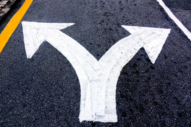 Close up arrow signs on asphalt city road