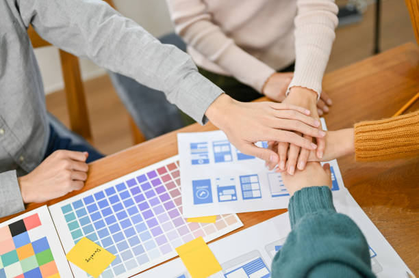 istock Top view, Team of UX developers and UI designer putting their hands together 1451246843