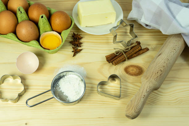 istock Background wallpaper for cooking. On the table, sprinkled with flour, there are baking tools and kitchen equipment. A set of cookie cutters of different types. 1451250103