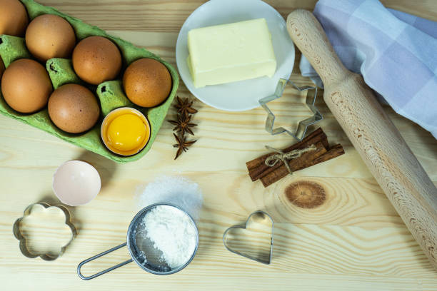istock Background wallpaper for cooking. On the table, sprinkled with flour, there are baking tools and kitchen equipment. A set of cookie cutters of different types. 1451250128