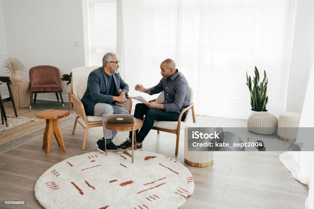 Ways to Minimize Workplace Uncertainty During Uncertain Times Client consulting 45-49 Years Stock Photo
