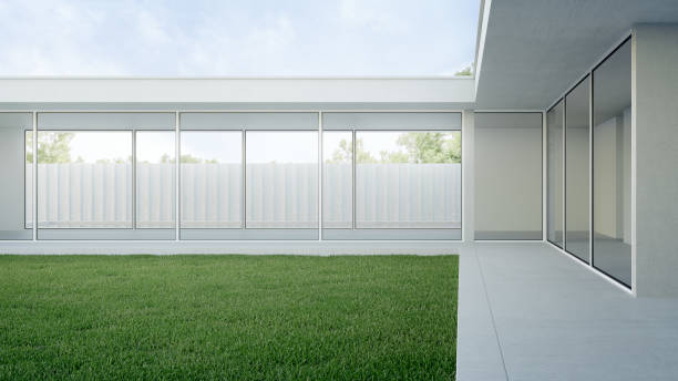 istock House with concrete terrace near empty grass floor courtyard. 1451262718