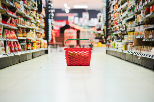 Grocery store, shopping basket or container on floor and food product, cooking ingredients or household sales goods. Supermarket, retail store or plastic carrier object for commercial consumer buying