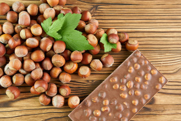 Hazelnut with a bar of milk chocolate in close-up.