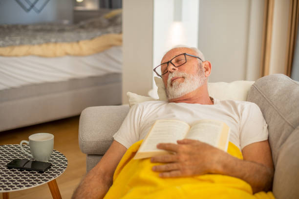 istock Man reading book at home 1451279225