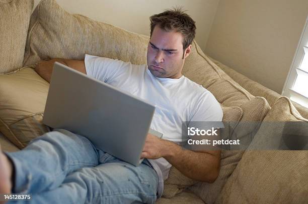 Young Man Relaxing At Home Stock Photo - Download Image Now - 20-29 Years, Adult, Brand Name Online Messaging Platform