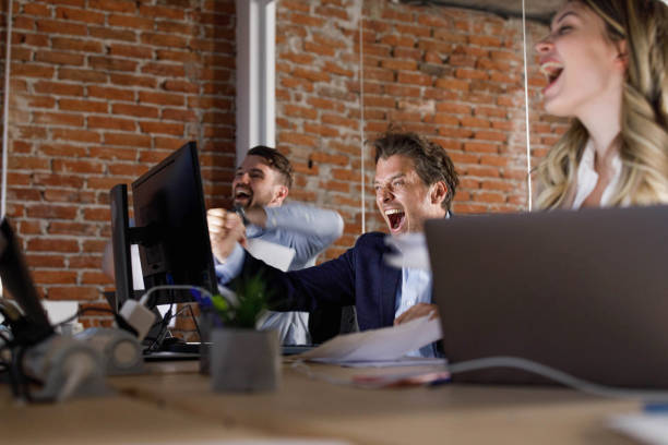 istock Cheerful entrepreneurs celebrating success in the office. 1451284730