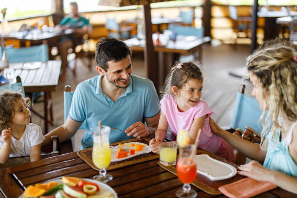 istock Happy family having lunch at restaurant's terrace. 1451285596