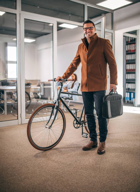 istock Businessman with bicycle in office 1451287443