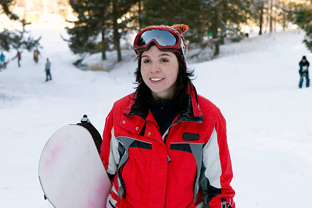 istock laughing beautiful girl snowborder 145129193