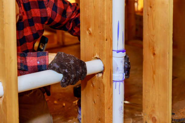 istock It is a plumbing technician gluing a PVC pipe to a plastic pipe using cement glue for the construction of a residential home 1451292705