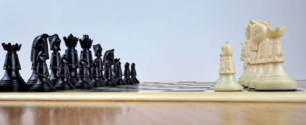istock Close-Up Of Chess Pieces On Chessboard Game Beginning 1451293392