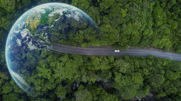 Electric car and EV electrical energy for environment, EV car on forest road with earth planet going through forest, Ecosystem ecology healthy environment, Electric car with nature, Save earth energy.