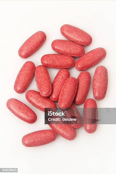 Scattered Red Vitamin Tablets On A White Surface Stock Photo - Download Image Now - Antibiotic, Chemistry, Dose