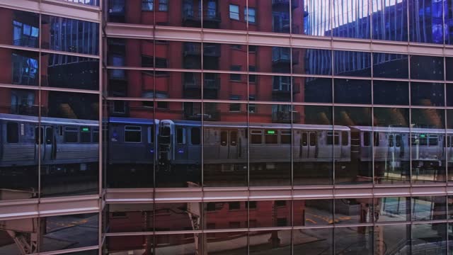 Reflection of Moving Railroad Car on Glass Windows of a Financial Building in Chicago, Illinois, USA