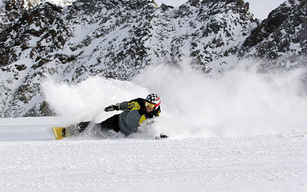 Extreme carving snowboarder stock photo