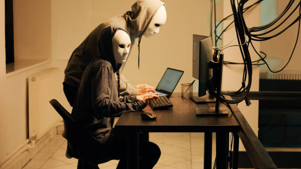 istock Hackers with white masks hacking network to steal passwords 1451304202