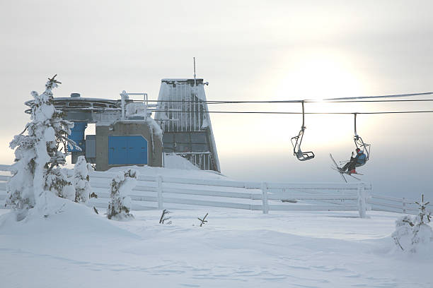 People sitting in a ski lift stock photo