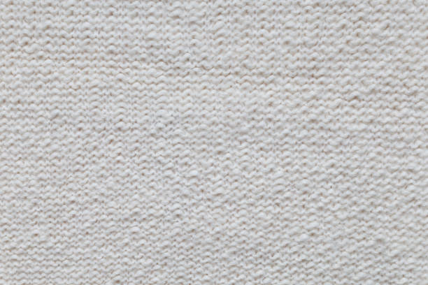 Texture of knitted woolen antique white fabric