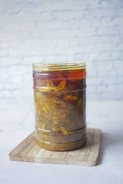 istock Homemade Mango Pickle in a glass jar on table , 1451305839