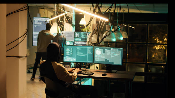 istock Young cyber criminal breaking computer firewall to plant malware 1451306558