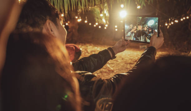 Group of young people having fun at night and taking selfies stock photo