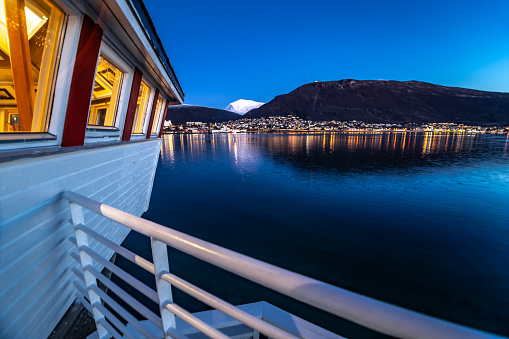 Local restaurant lights  twilight sky city of Tromso Northern Norway Scandinavia Europe