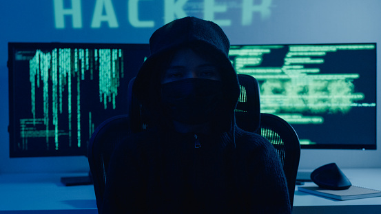Woman computer hacker breaks into government data servers and infects the system with virus in night. Cyber security concept.