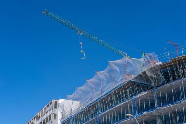 istock Construction cranes by the apartment buildings in Barcelona 1451313845