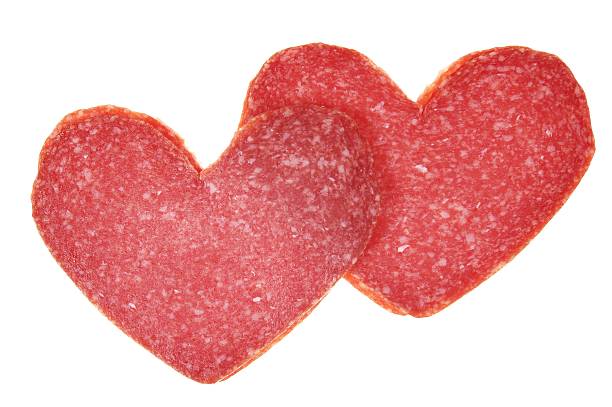 two red salami hearts stock photo