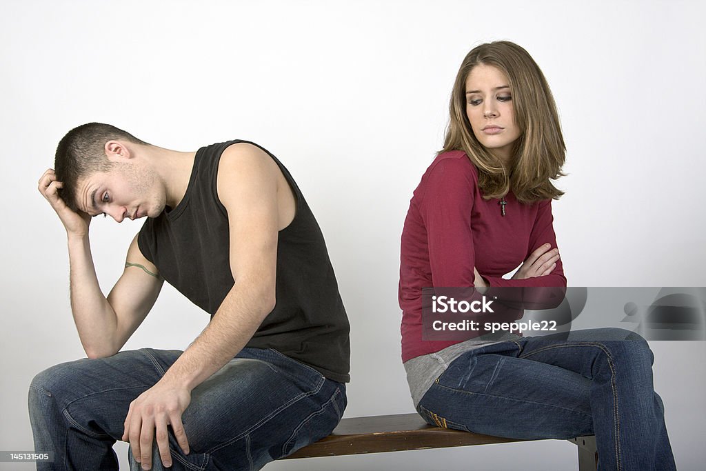 We just disagree Young couple sitting on a bench seemingly in a spat. Arguing Stock Photo