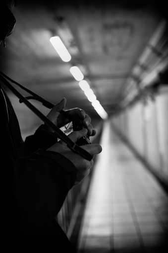 Image of a person looking at a camera monitor taken in a tunnel