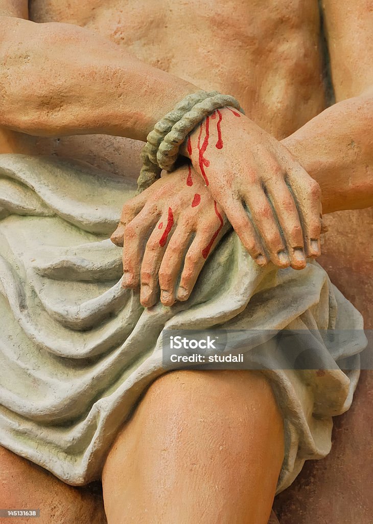 Jesus tied hands Stone statue of Jesus with crossed hands Jesus Christ Stock Photo