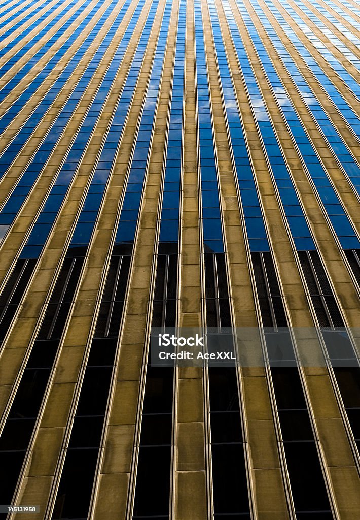 Architecture Super Highway Skyscraper in NYC with beautiful cloud reflections and a symmetrical vanishing point. Gold - Metal Stock Photo