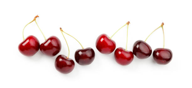 istock A row of ripe red cherries with stalks on a white background. 1451321000