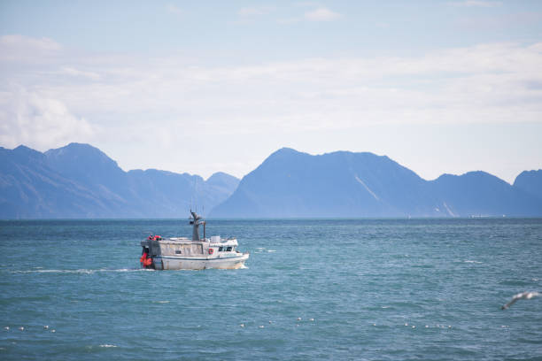 Alaskan fishing trawler making its way through icy water