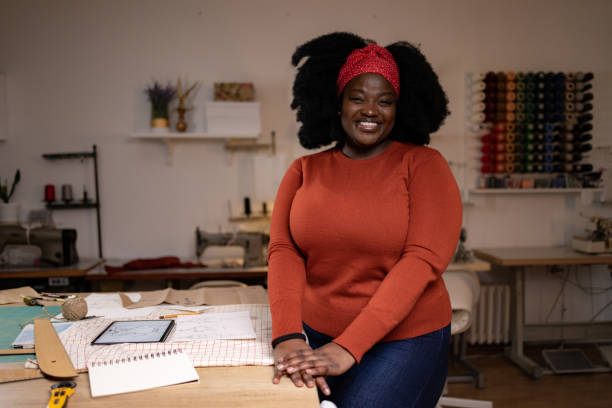 istock Happy black designer working on her sketches in a clothing design studio. 1451321067