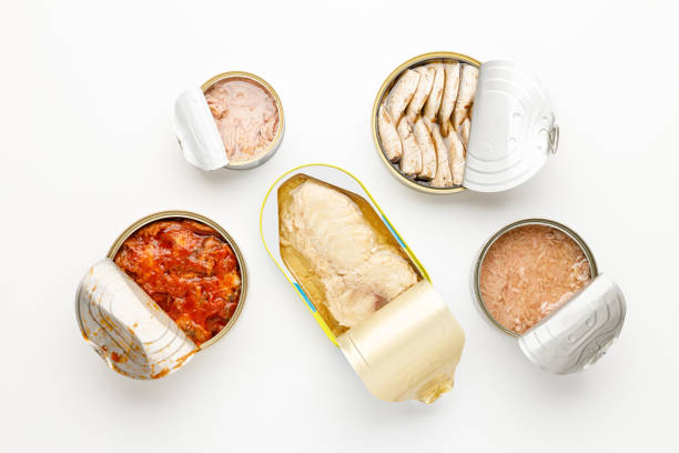istock Canned fish on a white background, open jars with tuna, sprat and mackerel. 1451321069