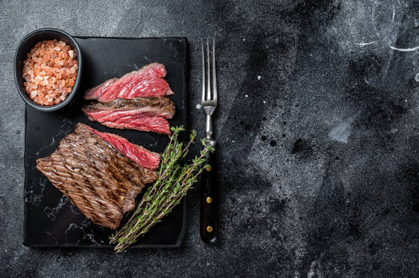 grilled wild venison steak with thyme and salt, game meat. black background. top view. copy space - venison imagens e fotografias de stock