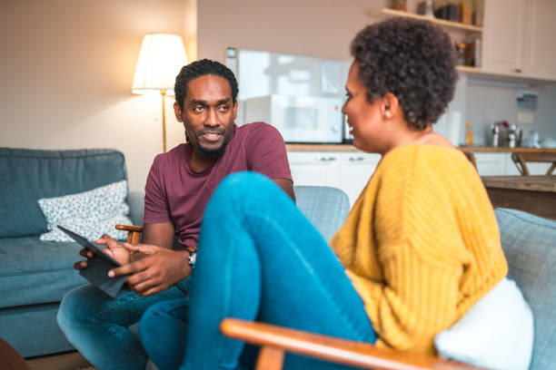istock Latin Male And Mixed Race Female In 30s Hanging Out  Using A Digital Tablet 1451321442