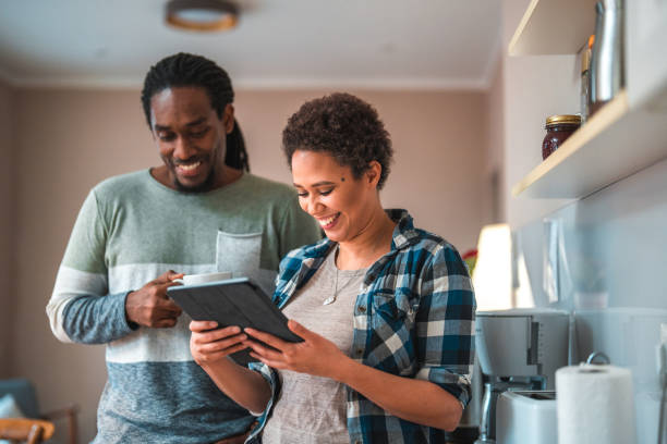 istock Lovely Couple Using Digital Tablet At Home 1451321711