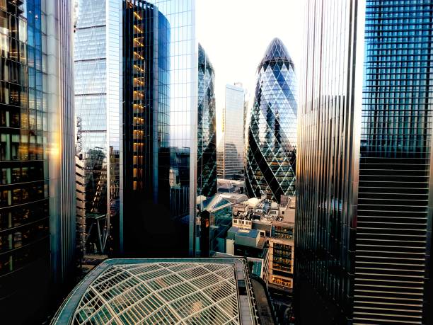 London futuristic financial district The ultra modern steel and glass architecture - including the Gherkin building- of London’s financial district. central london stock pictures, royalty-free photos & images